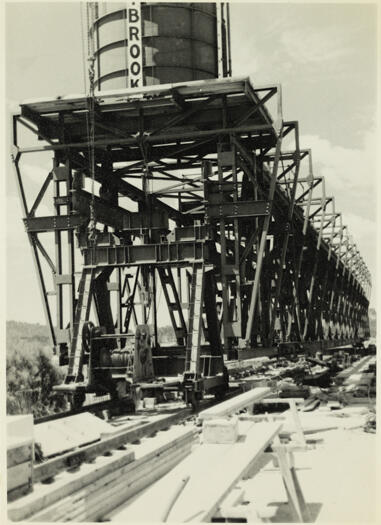 Kings Ave Bridge under construction. An angled view of two pre-stressed concrete beams in position on a pier after being lowered from a gantry.