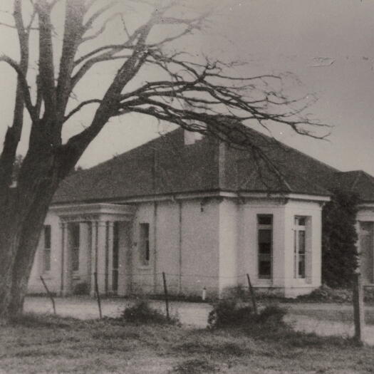 Courthouse at Acton. Originally Canberry House, then Acton Cottage. Photo shows the front of the building with a road running in front. It may be winter as trees do not have leaves.