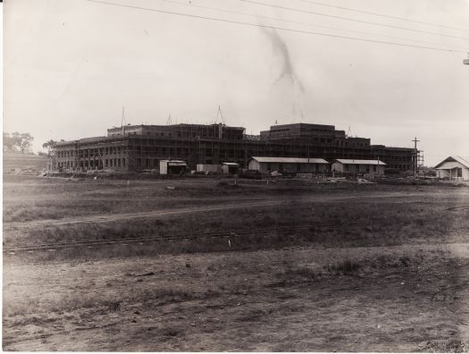 Parliament House under construction, view of front from the north east showing the temporary construction railway line from the brickworks at Yarralumla.