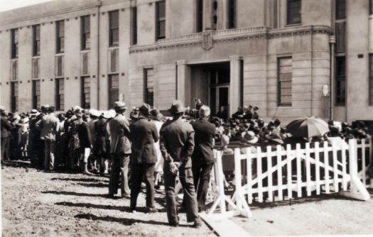 Opening of Canberra High School from NW corner behind barricades - speech being given on front steps