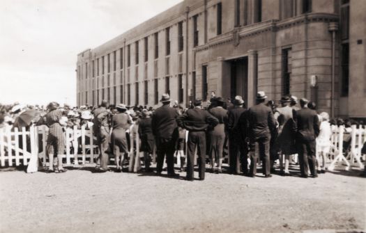 Opening of Canberra High School from NW corner behind barricades - speech being given on front steps