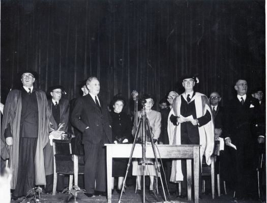 Conferring of ANU degrees at Albert Hall. L to R; Sir Douglas Copland, Sir John Medley, Ben Chifley, Mrs Chifley, others unnamed.