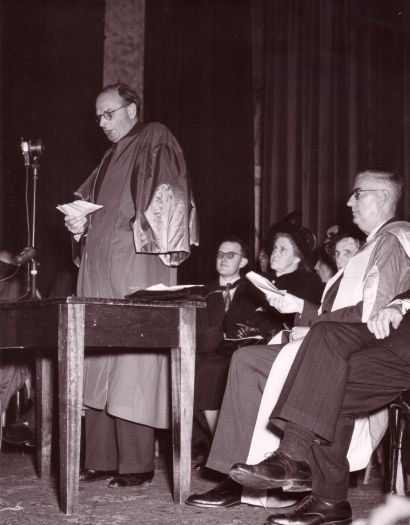 Conferring of ANU degrees at Albert Hall. Sir John Medley speaking, Mrs Chifley and others seated.