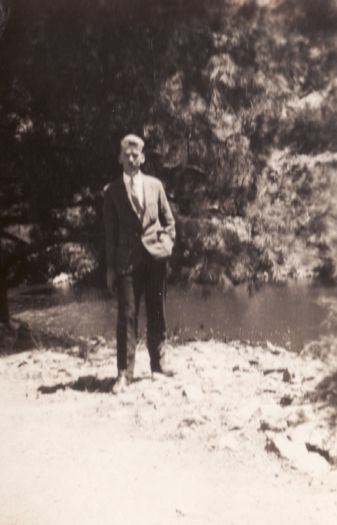 Man standing beside a creek