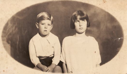 Portrait of boy about six, and girl about 10 years old