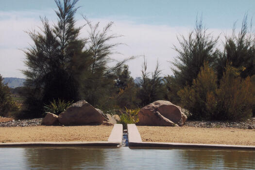 ACT Bushfire Memorial showing the pond and stream through casaurinas