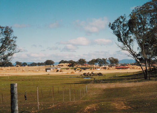 View from Mulligans Flat Reserve towards the suburb of Gungahlin. A park near Eva West Street is visible.
