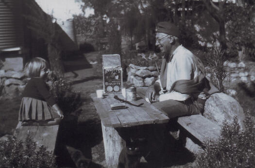Nan Dixon and her father Oswald Dixon sitting either side of a picnic table at Kama.