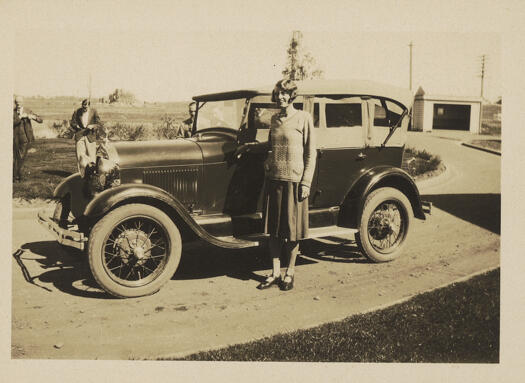 Gertrude Swindell standing alongside her car known as Betty Ford