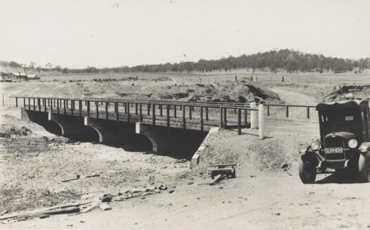 Scotts Crossing bridge over the Molonglo River c1928 or 1929 with Chevrolet motor truck (licence plate L34634) at right and Blundell's Cottage at left. New bridge under construction.