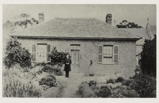 Father James McAuliffe is posing at the front door.