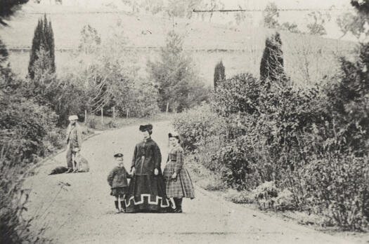 Lady, Gentleman and two girls on driveway.