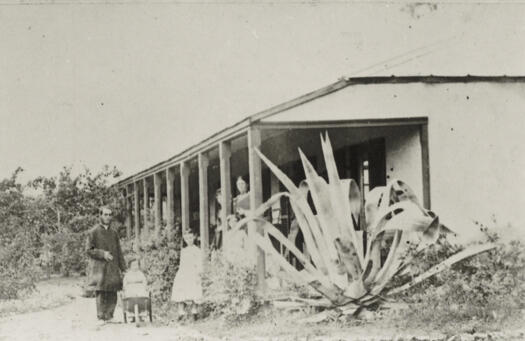 Reverend Pierce Galliard Smith and family posing on verandah.