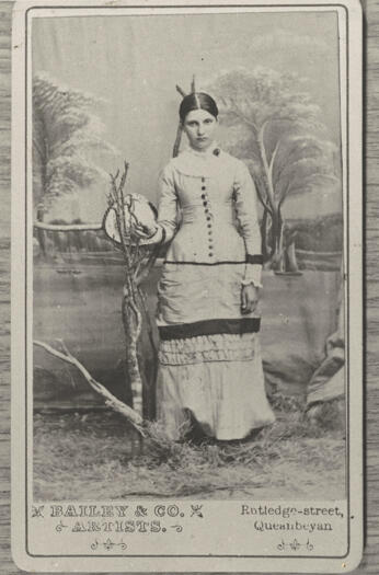 Studio portrait by Bailey & Co, artists. Rutledge Street, Queanbeyan. Background is a lake scene (painted?).