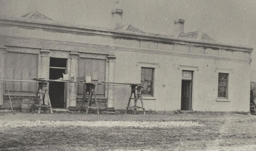 The building is still being completed when photographed in 1870. Quite a formal look with pillars and door and window frames.