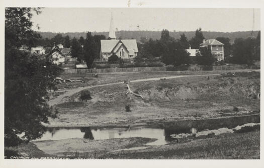 Looking across a rather low river towards the church.