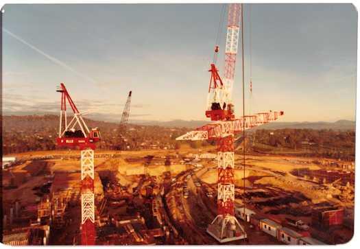 Construction work on the Ministerial wing and Senate buildings. Adelaide Avenue is visible behind a crane.