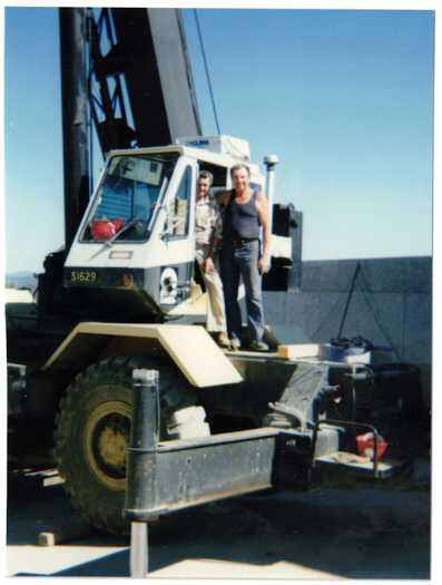 Alfred Chambers standing outside the crane cabin with the operator